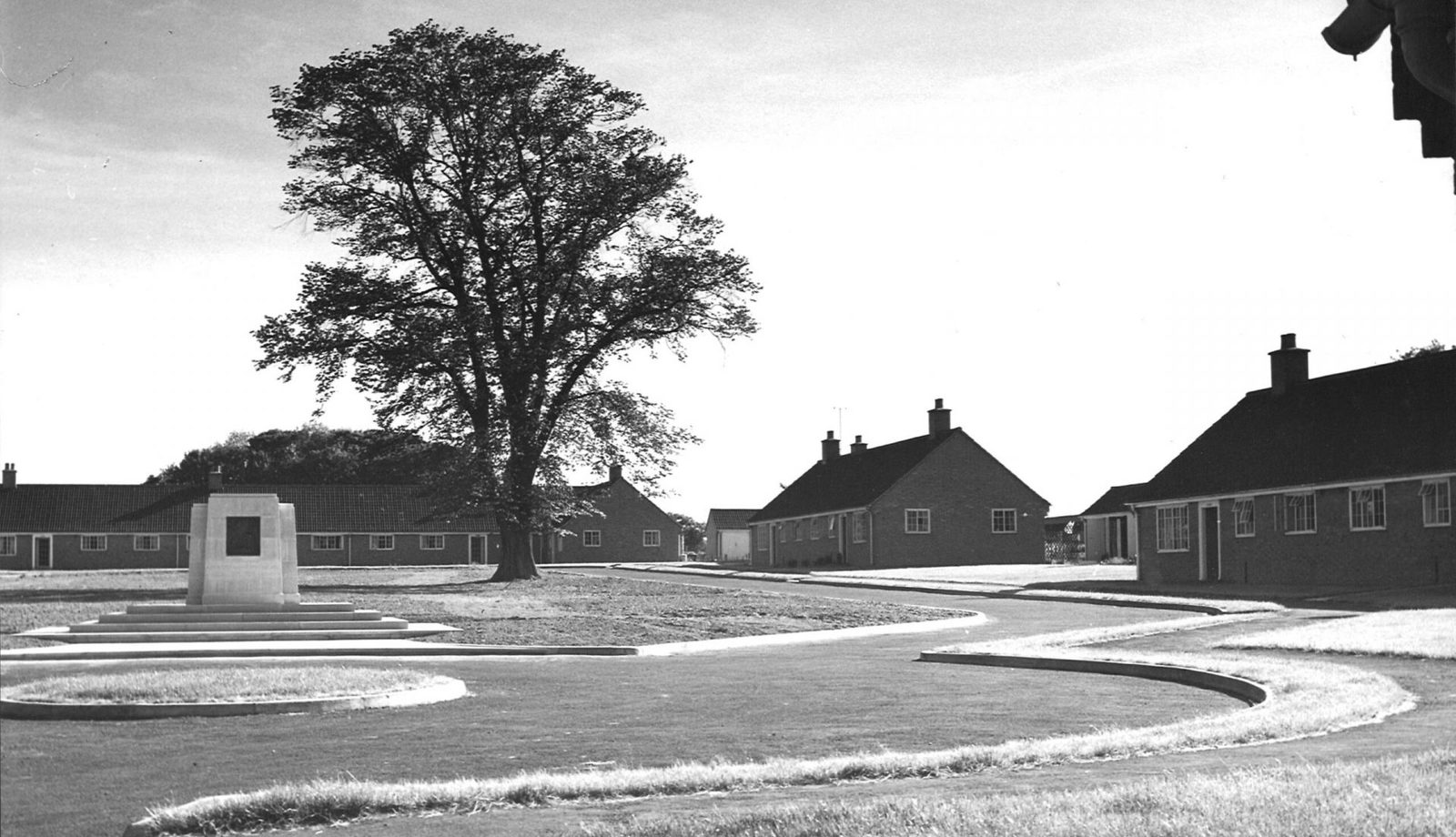 The black and white image shows the Agnes Hunt memorial and bungalows at the Agnes Hunt Village shortly after it was built in 1952.