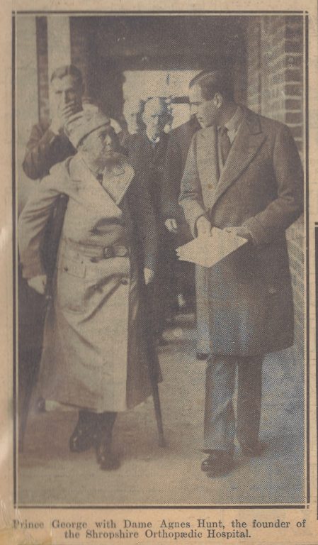 Black and white photo: Dame Agnes Hunt talks to Prince George
