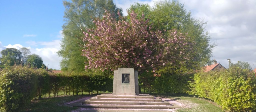 Agnes Hunt memorial stone under cherry blossom