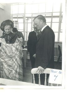 Mr Jim Kendall shows the HRH The Duchess of Kent around the dressmaking workshop