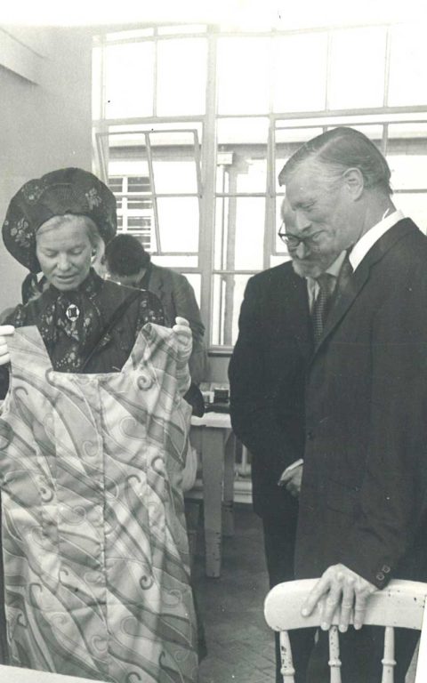 Jim Kendall looks at a dress held by the duchess of kent