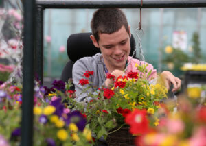 Horticulture student tending plants in the greenhouse