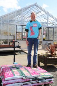 Derwen College Plant Production Manager Paul Moss is wearing a Derwen Charity Easter Challenge t-shirt in preparation for the fundraising event.