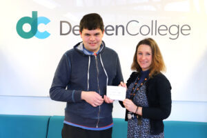 Student Mark hands over a cheque for £180 to Derwen College fundraiser Anna Evans.