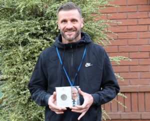 Derwen College Sports and Leisure Coordinator Steve Evans shows off his specially commissioned Duke of Edinburgh's Awards coin.