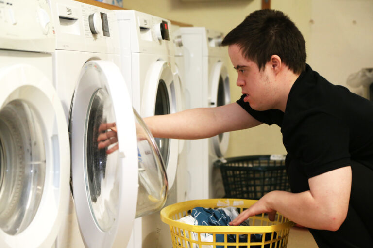 Student loading washing machine