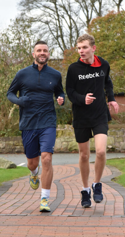 Student and sports teacher out for a run