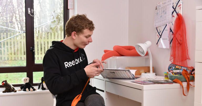 Student at desk in bedroom