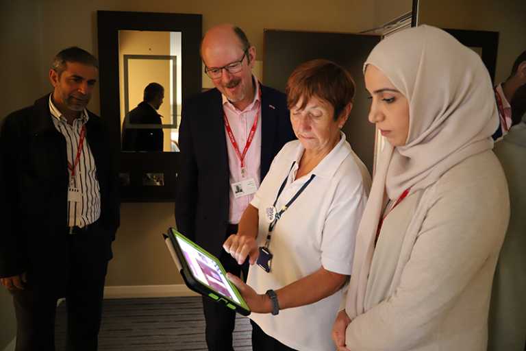 Derwen College staff show visitors the Premier Inn training app