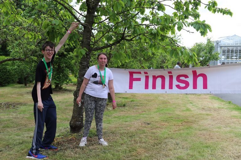 Students Joe and Maisy pictured at the Finish line of Derwen College Sponsored Walk and Fun Run.