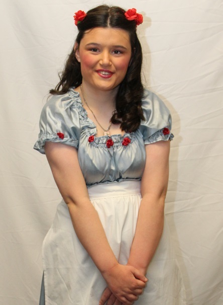 Amy wearing a dress and apron with red flowers in her hair as Belle in Beauty and the Beast
