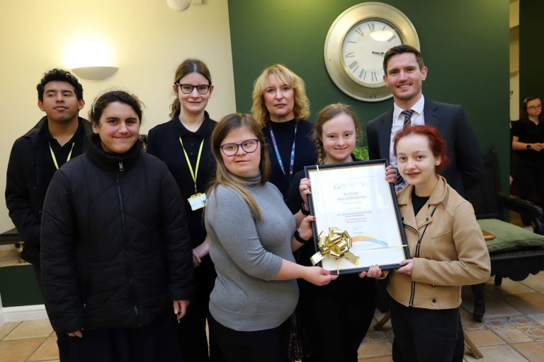 Students from our Student Union Board pictured holding the NAS accreditation certificate with Derwen Head of Quality Dawn Roberts and NAS assessor Jonny Knowles.
