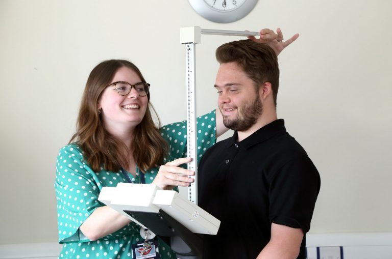 Nurse measures a student's height