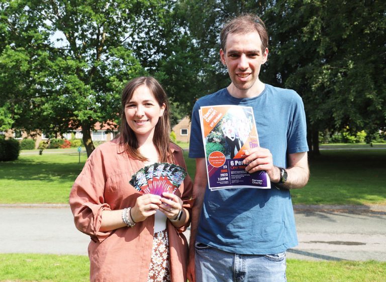Take Five singer Bekah Plaisted and her brother Sam stand together holding charity concert tickets and posters.