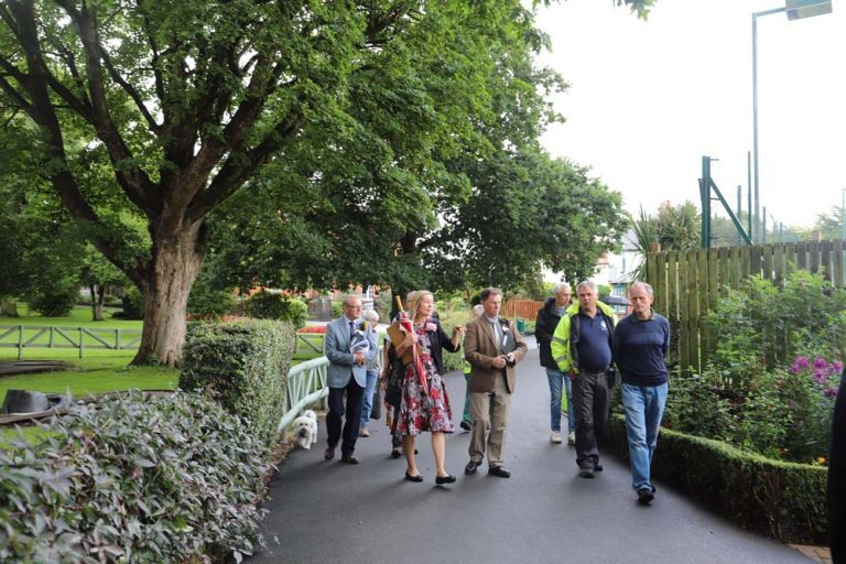 Paul, Anton and Thomas take a walk through the park with judges - dressed in smart suits - and the Oswestry in Bloom team.