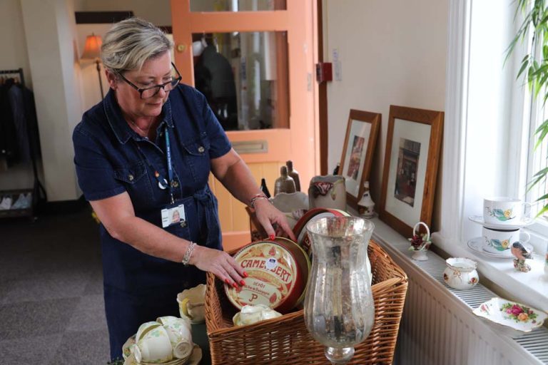 Commercial supervisor Sharon Jones arranges a display of vintage tableware in the Derwen Marketplace pop-up shop.