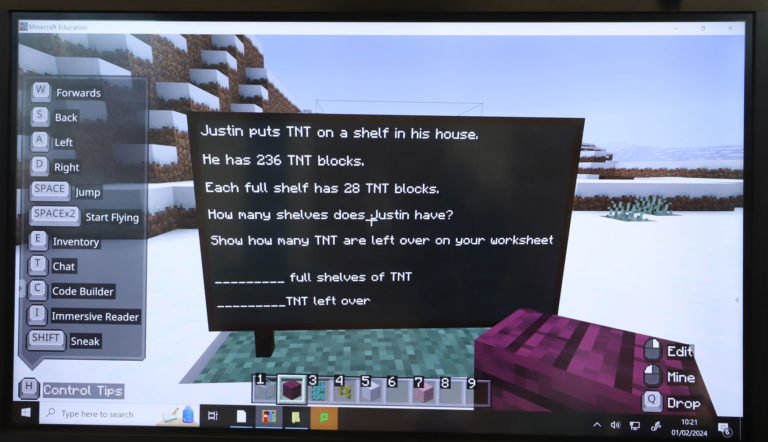 Image shows Minecraft screen with example maths problem in Justin's Minecraft world.