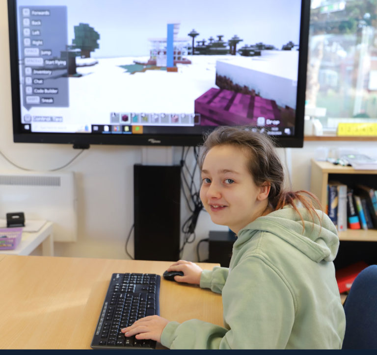 Photo shows Meg enjoying learning maths through Minecraft