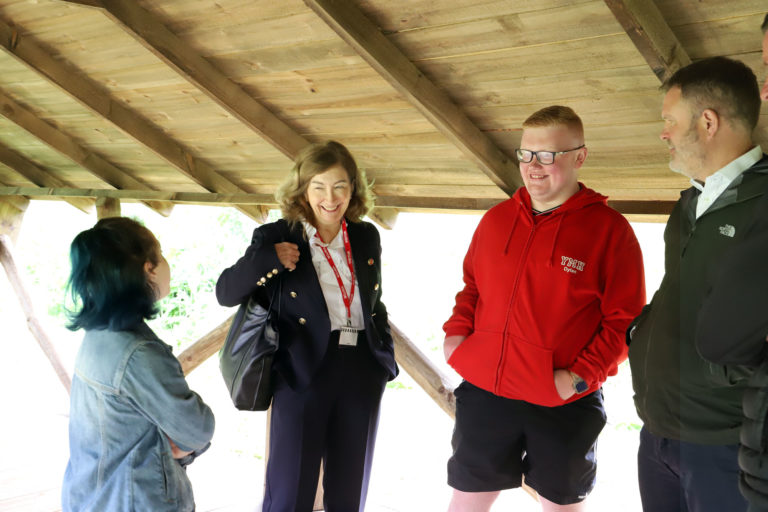 Group of people standing talking to each other