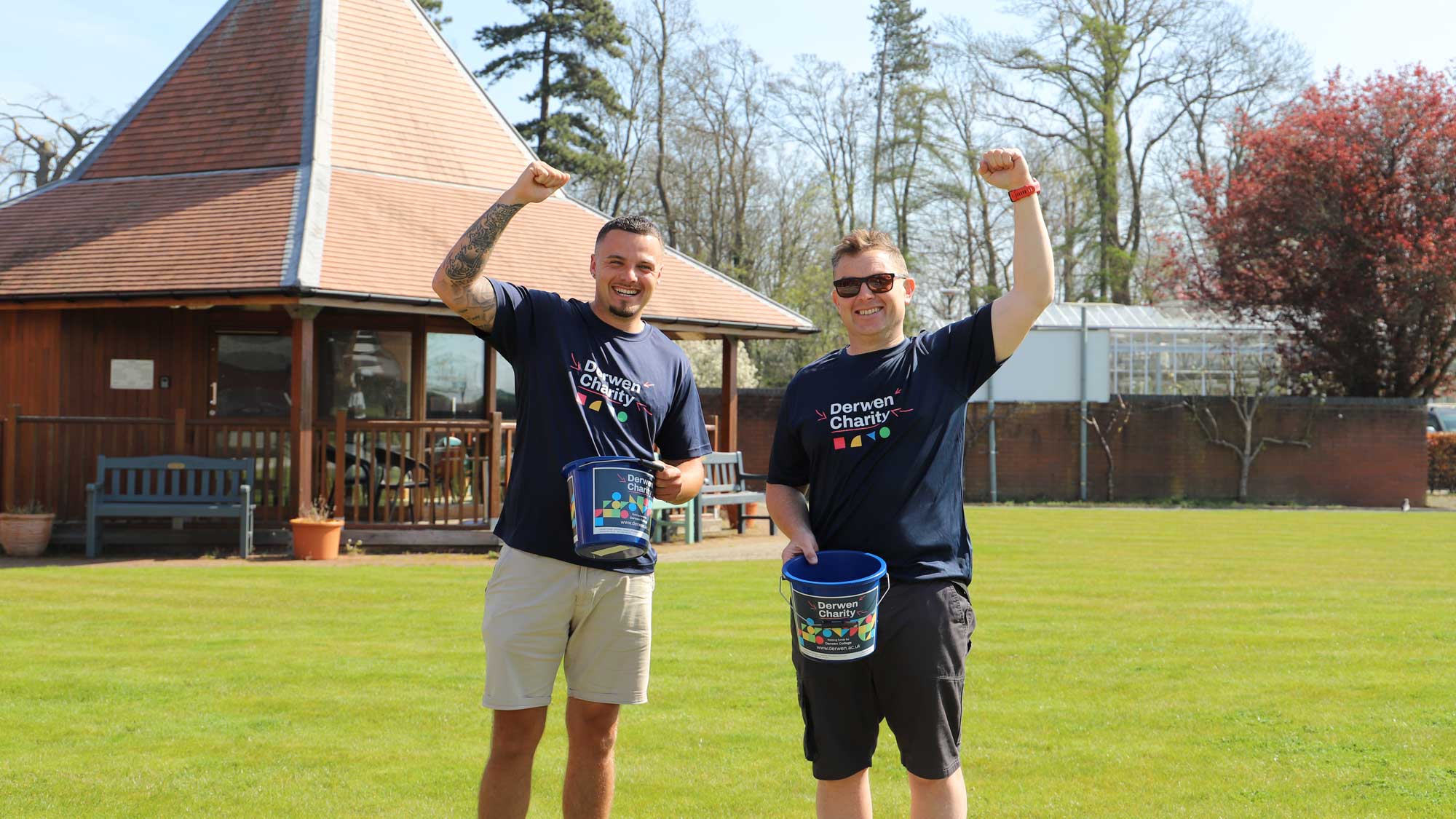 Dan and Connor holding Derwen Charity buckets