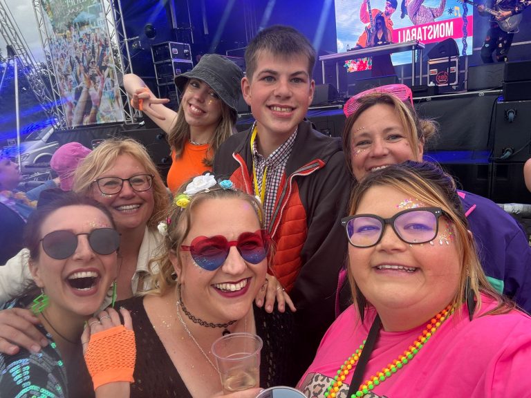 DJ Ollie surrounded by colourfully dressed revellers at Alderfest.