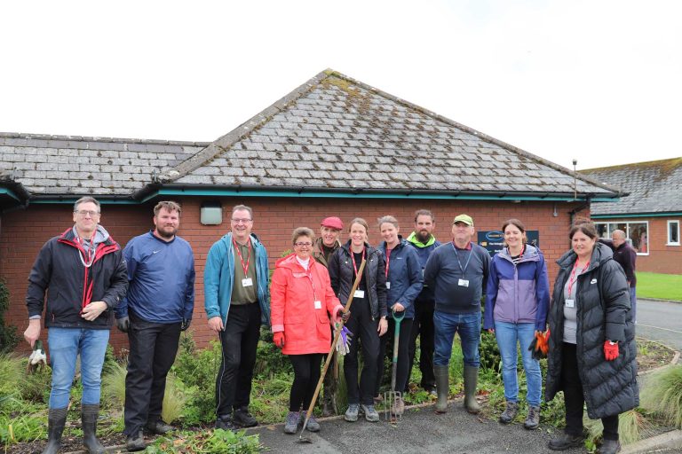 a group of people standing outside the garden centre