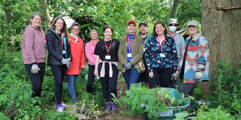 group of people standing in the woodland