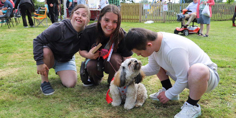 three people with a dog