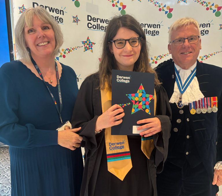 Derwen College Principal, Freya wearing a graduation gown and sash and holding a Derwen College Graduation certificate, and High Sheriff wearing medals. All stood in front of backdrop with Derwen College logos.