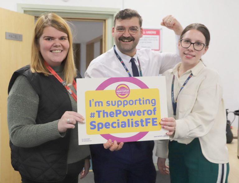 Pathway leads Jessie, David and Katie hold a sign saying 'I'm supporting #ThePowerofSpecialistFE' with David holding up arm in strong man pose.
