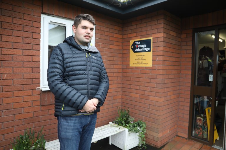 Former student Mark stood outside The Vintage Advantage charity shop