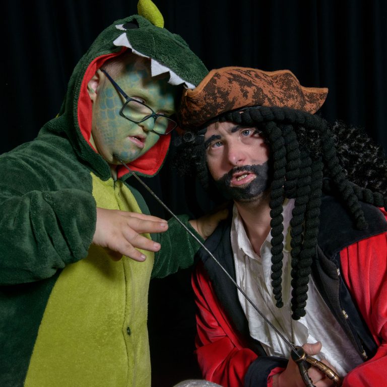 Josh dressed as a crocodile and Joe as Captain Hook looking at each other threateningly
