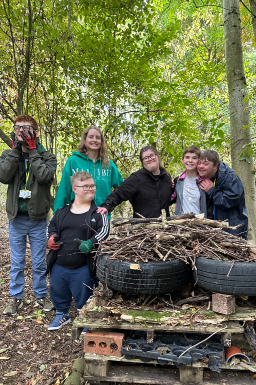 students standing next to a bug house