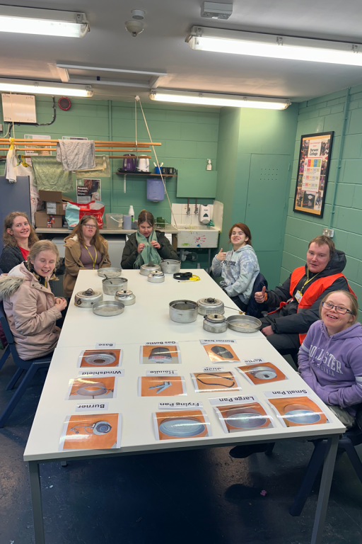 students sitting around a table doing trangia expedition training
