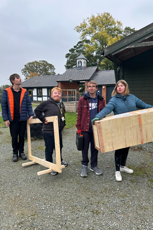 students carrying wood at the dofe centre