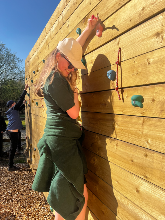dofe student climbing the traversing wall