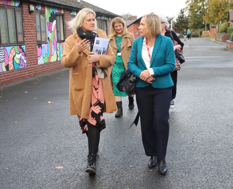 Helen Morgan walking through campus with staff members