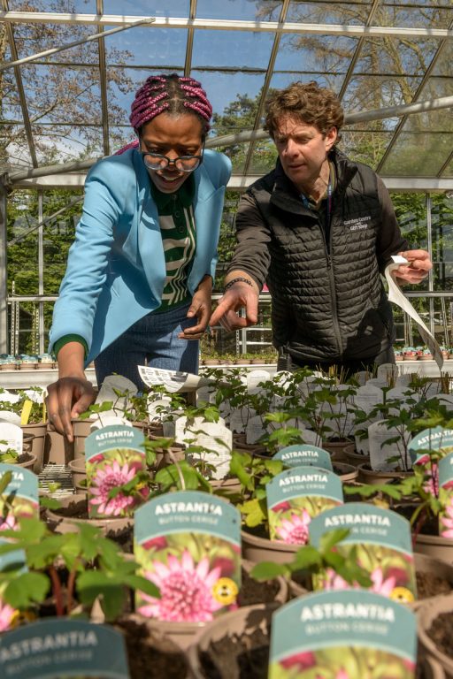 student and staff in the greenhouse