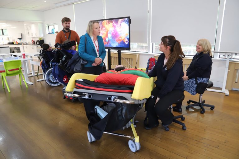 Helen talking to students and staff in the Nurture building for young people with PMLD.