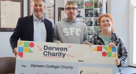 Karl (left) presents a cheque for £1,200 to students Jonathan and Claudia